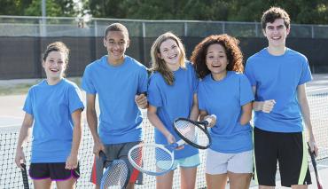 Young people at tennis lesson